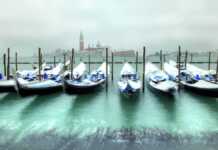 Gondolas In Venice At Cold, Windy Snowy Winter Day