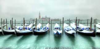 Gondolas In Venice At Cold, Windy Snowy Winter Day