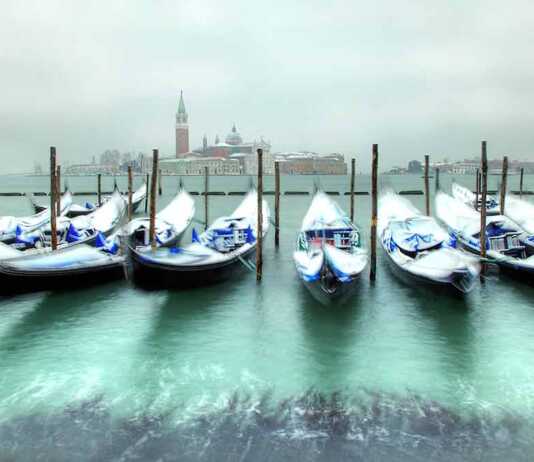 Gondolas In Venice At Cold, Windy Snowy Winter Day