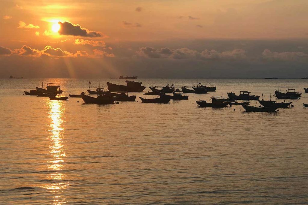 boats on the ocean in Vung Tau at sunset