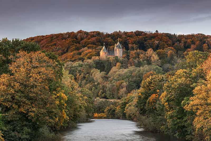 wales castle coch surrounded by autumn forest
