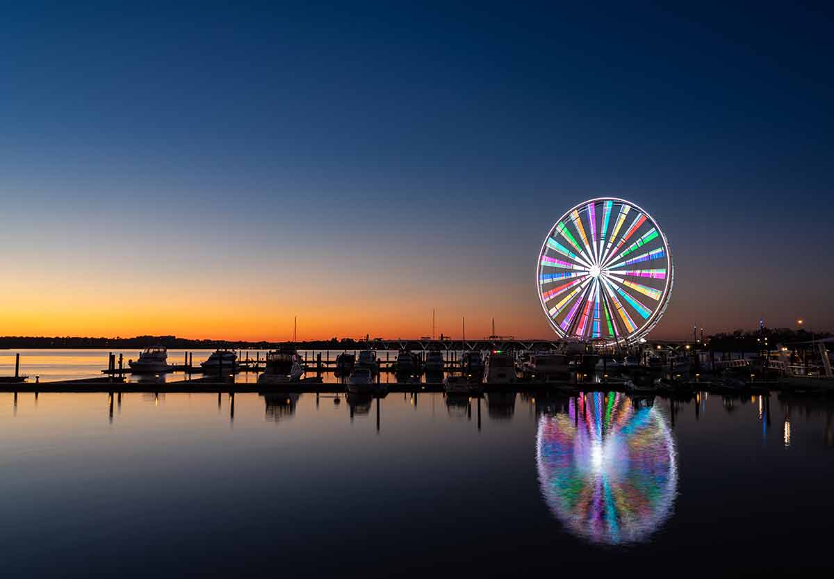 washington dc skyline at night Illuminated ferris wheel at National Harbor
