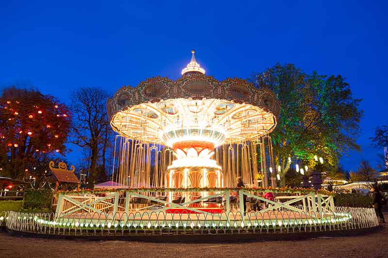 Illuminated Carousel At Tivoli Gardens In Copenhagen