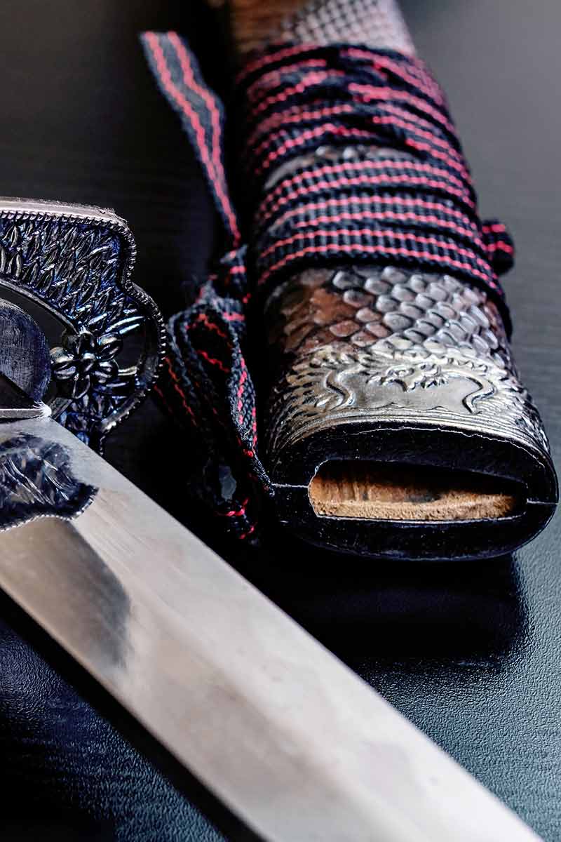 Samurai Sword On A Black Wooden Table