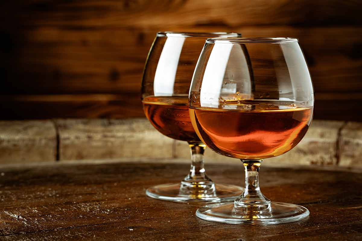 Two Glasses Of Whiskey On A Wooden Table