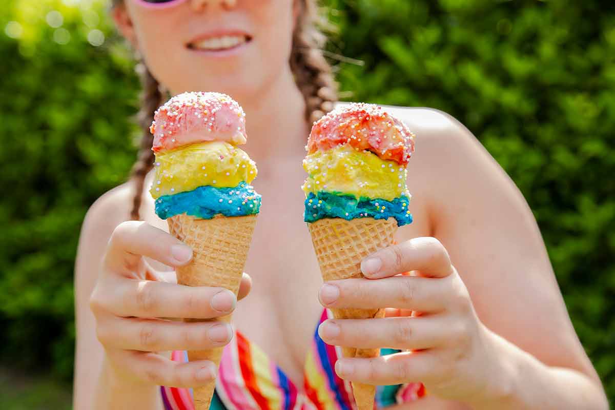 Beautiful Girl Holding Two Colorful Ice Cream