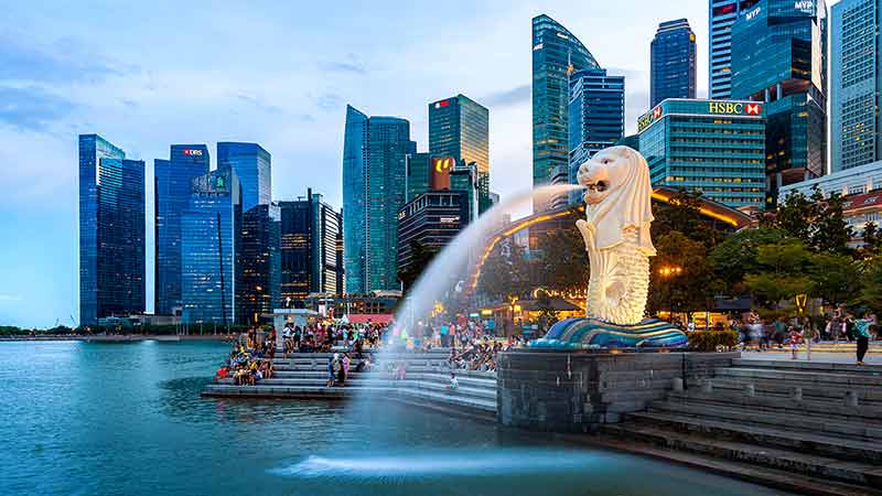 Merlion Statue And Cityscape In Singapore