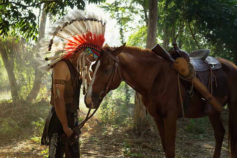 The Indians Are Riding A Horse And Spear Ready To Use