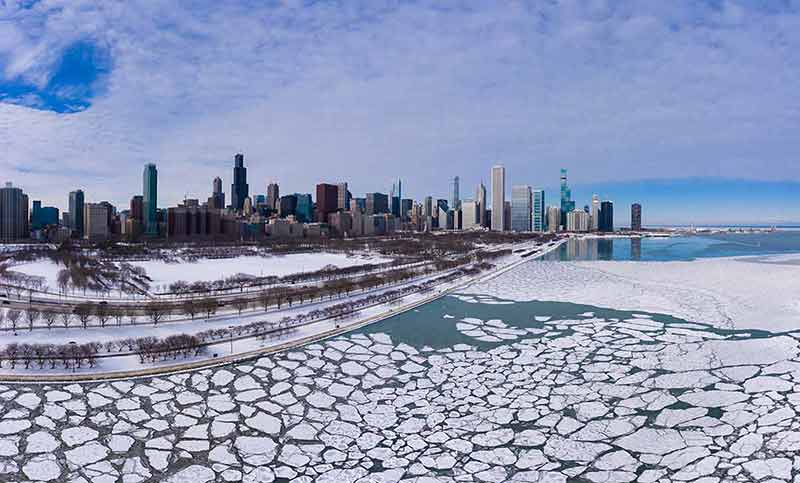Urban Skyline Of Chicago Loop And Frozen Lake Michigan