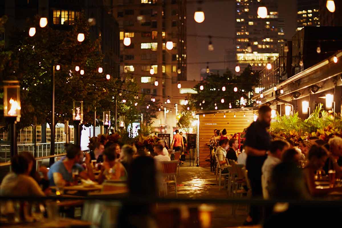 what to do in toronto at night people dining on an outdoor patio
