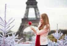 what to wear in winter in paris girl with caramel apple in Paris near the Eiffel Tower.
