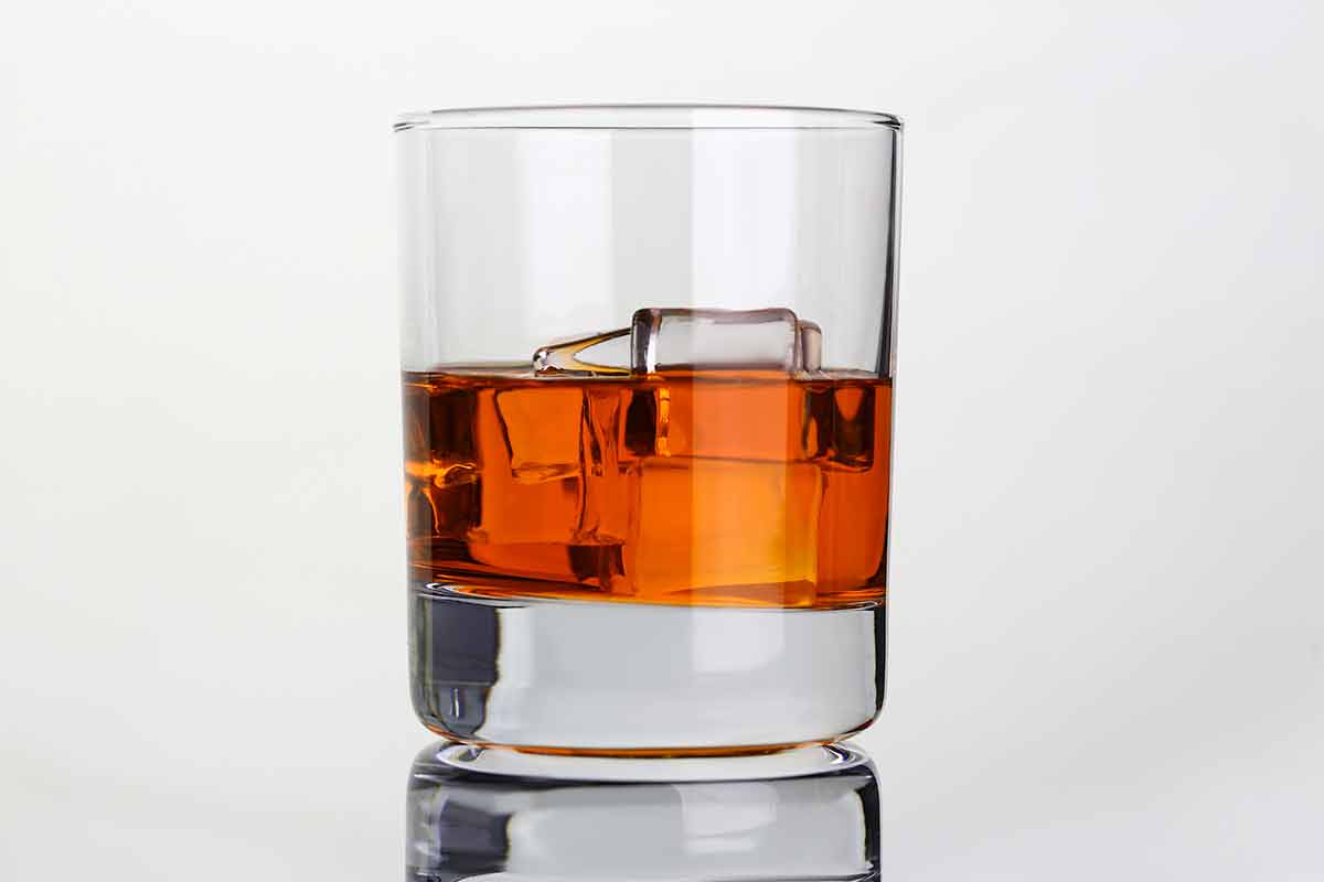 when is the best time of year to visit ireland Whiskey with ice in glass beaker on gray background