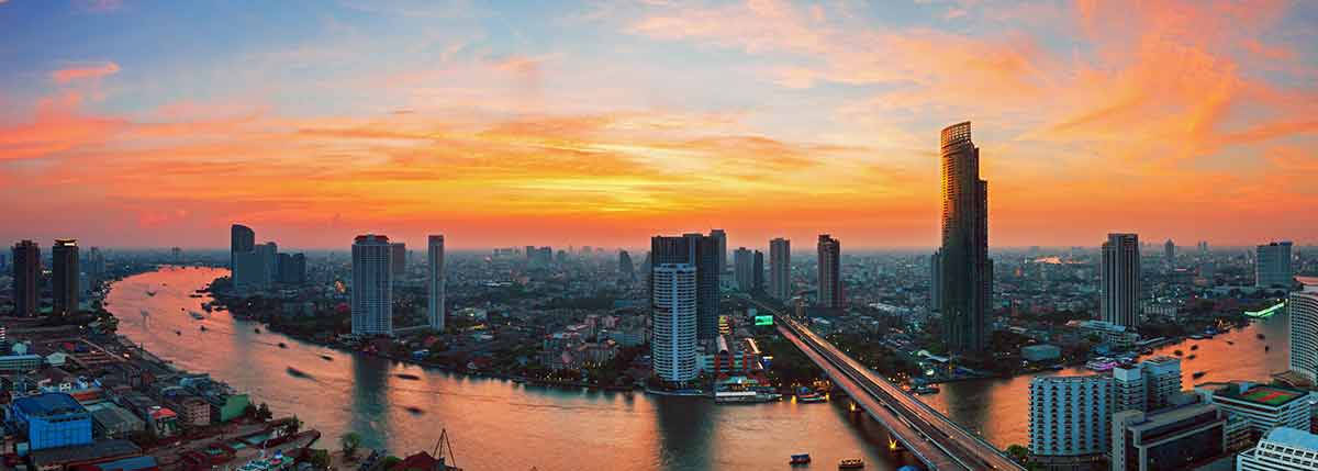 Bangkok river and buildings at sunset