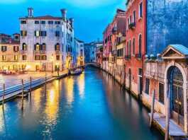 View Over A Picturesque Canal At Night In Venice, Italy