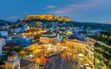 where to stay in athens for cheap cityscape with The Acropolis and the Parthenon Temple in Greece at sunset from Monastiraki Square.