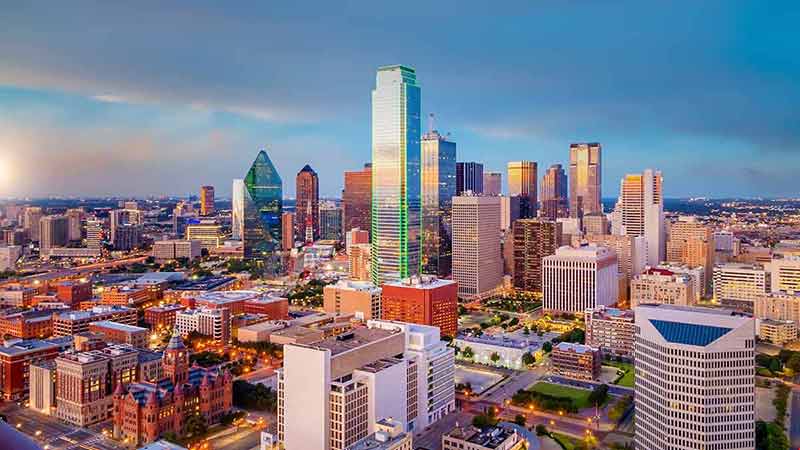 where to stay in dallas for cheap Dallas city downtown skyline cityscape of Texas USA at sunset.