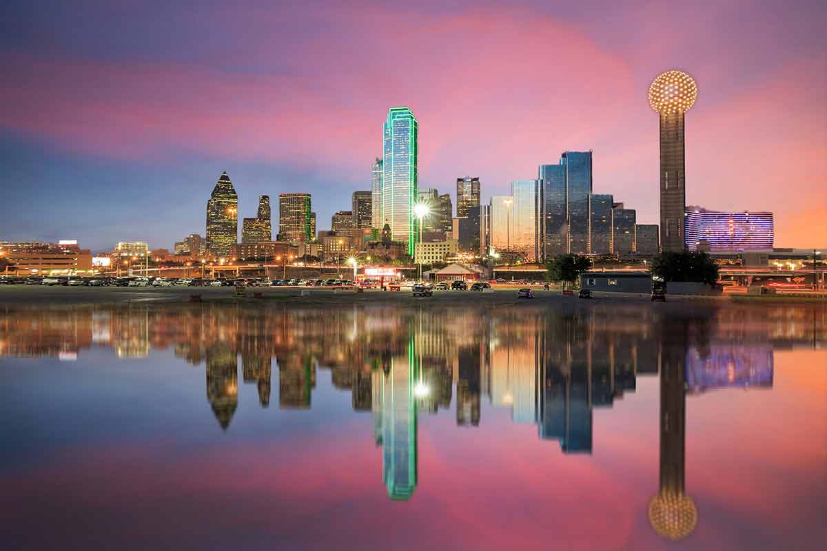 where to stay in dallas for nightlife city skylne reflected in the Trinity River