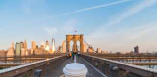 Hand holding coffee cup in New York City.