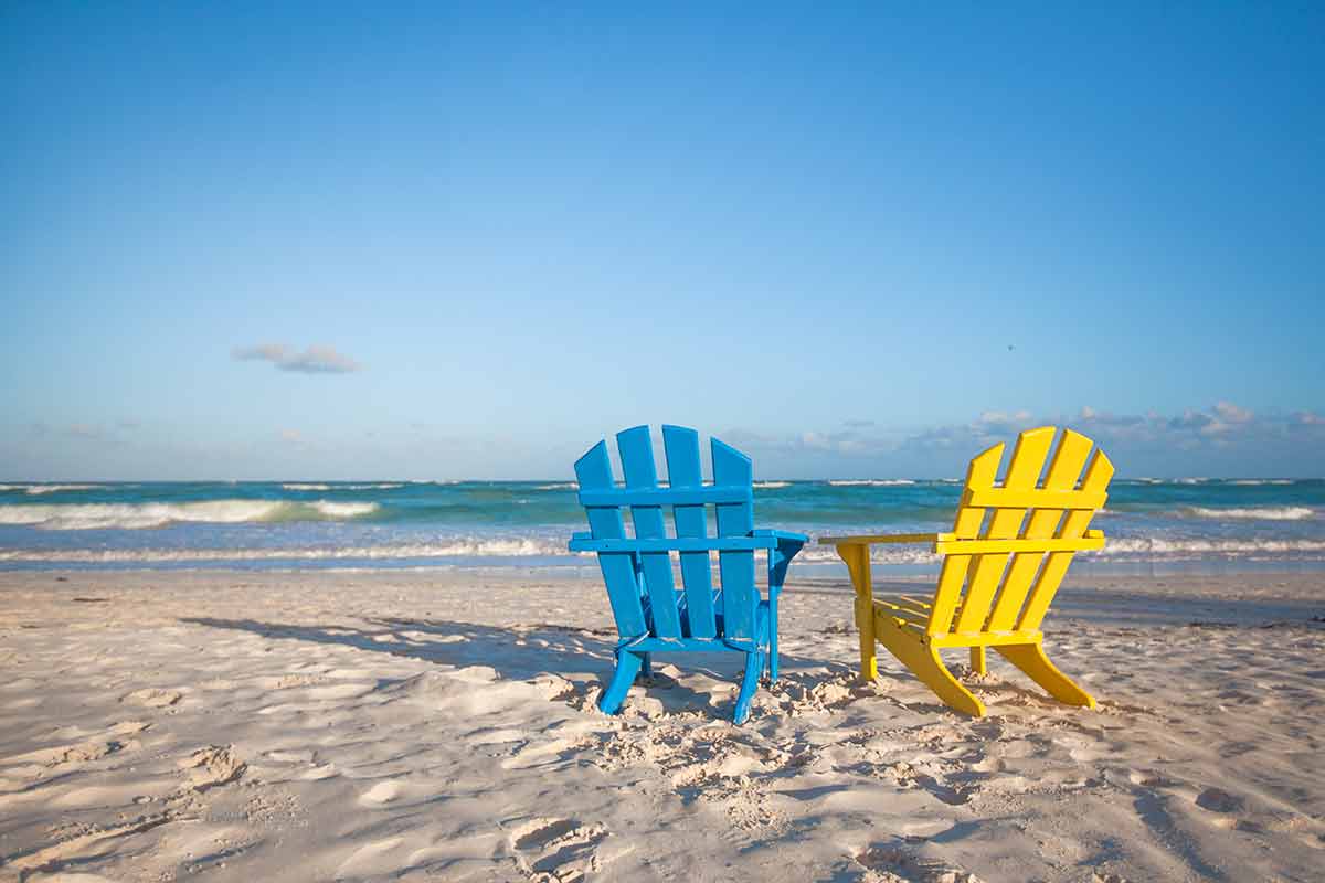 where to stay in tulum area blue and yellow beach chairs on the sand