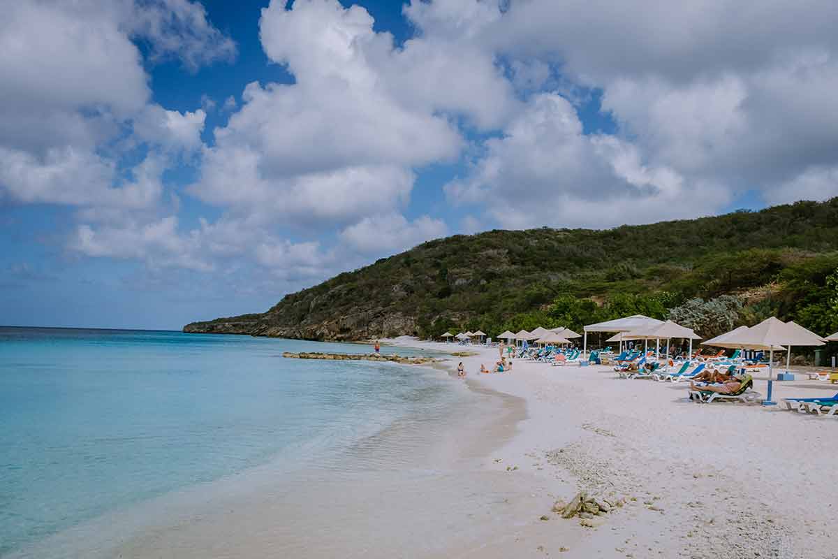 willemstad curacao beaches day beds and umbrellas with tourists