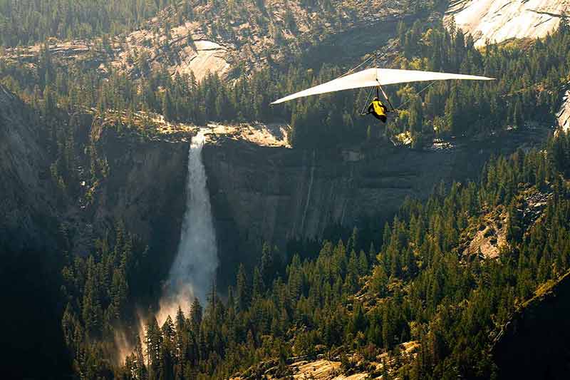 hang glider over a waterfall in yosemite national parks in california